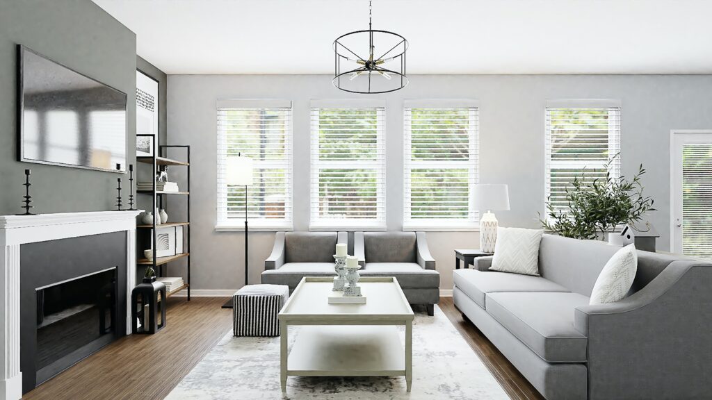 A modern living room with gray sofas, a white coffee table, a fireplace, a wall-mounted TV, bookshelves, a floor lamp, and three windows with white blinds. The room boasts light gray walls and wood flooring. It offers serene views reminiscent of Lake Martin's tranquility.