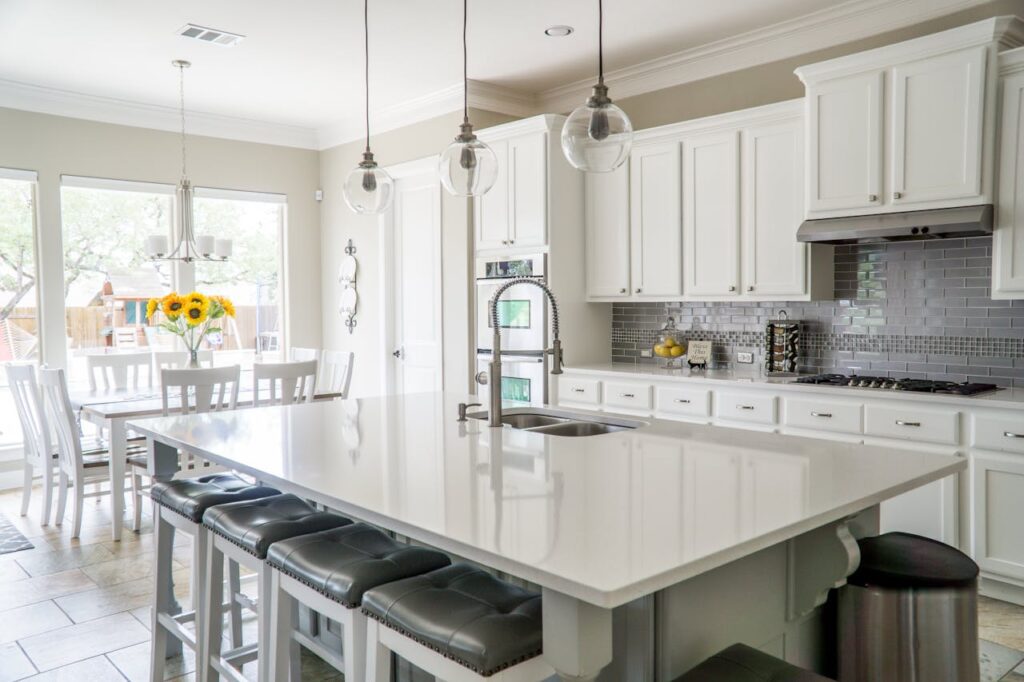 White kitchen island with bar stools.