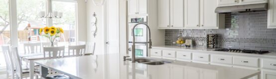 White kitchen island with bar stools.